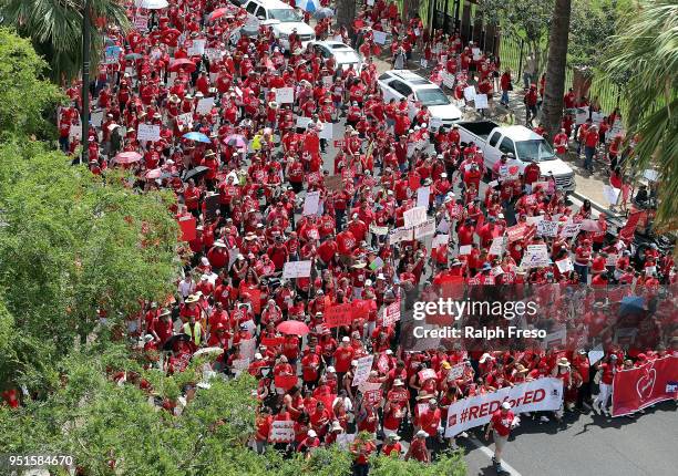 Arizona teachers march through downtown Phoenix on their way to the State Capitol on April 26, 2018 in Phoenix, Arizona. Teachers state-wide staged a...