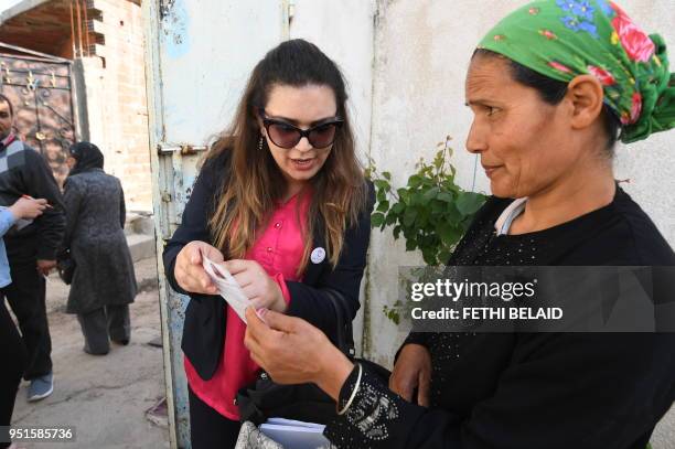 Head of Nidaa Tounes party list for the municipal elections in the Locality of Tebourba, Ines Boussetta speaks with Tunisian citizens as she...