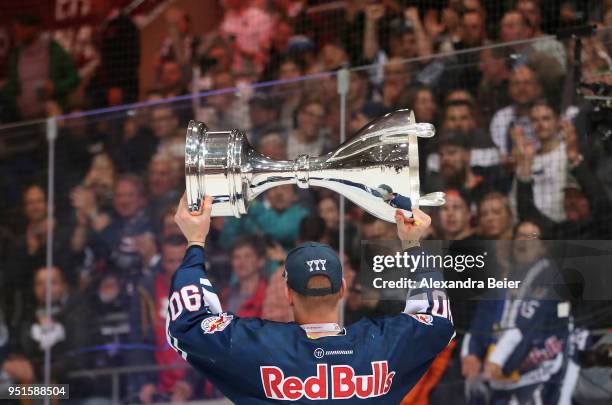 Jerome Flaake of EHC Red Bull Muenchen holds up the German Championship trophy after winning the DEL Play-offs Final Match 7 between EHC Red Bull...