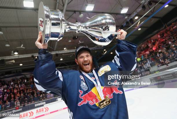 Goalkeeper Danny aus den Birken of EHC Red Bull Muenchen holds up the German Championship trophy after winning the DEL Play-offs Final Match 7...