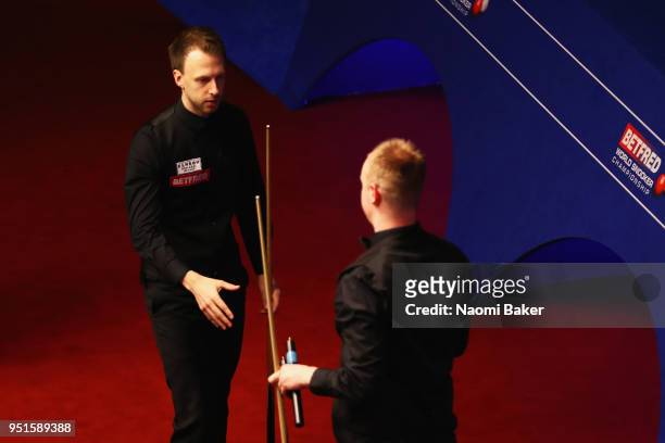 Judd Trump of England shakes hands after winning his first round match against Chris Wakelin of England during day six of the World Snooker...