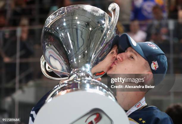 Jerome Flaake of EHC Red Bull Muenchen kisses the German Championship trophy after winning the DEL Play-offs Final Match 7 between EHC Red Bull...