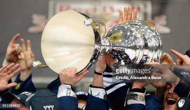 Players of EHC Red Bull Muenchen hold up the German Championship trophy after winning the DEL Play-offs Final Match 7 between EHC Red Bull Muenchen...