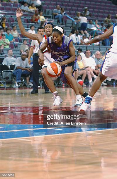 Kedra Holland-Corn of the Sacramento Monarchs drives the lane past Deanna Nolan of the Detroit Shock during the game on June 30, 2002 at the Palace...