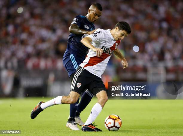 Ignacio Fernandez of River Plate fights for the ball with Dixon Arroyo of Emelec during a match between River Plate and Emelec as part of Copa...