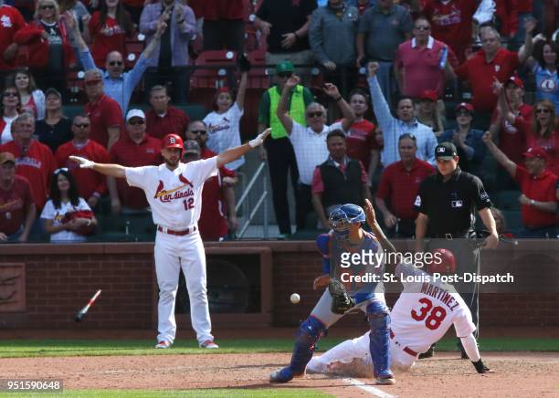The St. Louis Cardinals' Jose Martinez scores the game-winning run behind New York Mets catcher Jose Lobaton on a single by Dexter Fowler in the 13th...