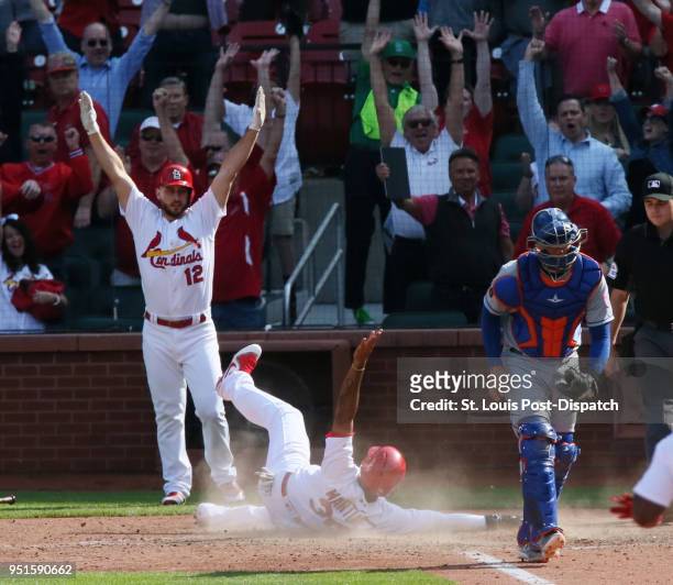 The St. Louis Cardinals' Jose Martinez scores the game-winning run behind New York Mets catcher Jose Lobaton on a single by Dexter Fowler in the 13th...