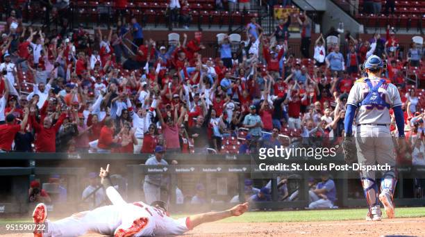 The St. Louis Cardinals' Jose Martinez, left, scores the game-winning run behind New York Mets catcher Jose Lobaton on a single by Dexter Fowler in...