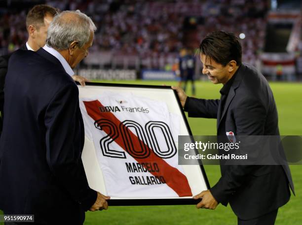 Marcelo Gallardo coach of River Plate reaceives a jersey to celebrate his 200th match from Roldolfo D'Onofrio President of River Plate prior a match...