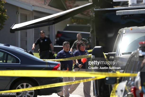 Investigators stand in front of the home of accused rapist and killer Joseph James DeAngelo on April 24, 2018 in Citrus Heights, California....