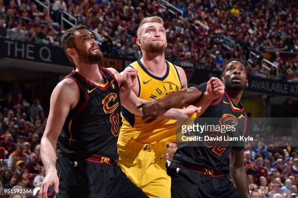 Kevin Love of the Cleveland Cavaliers and Jeff Green of the Cleveland Cavaliers play defense against Domantas Sabonis of the Indiana Pacers in Game...