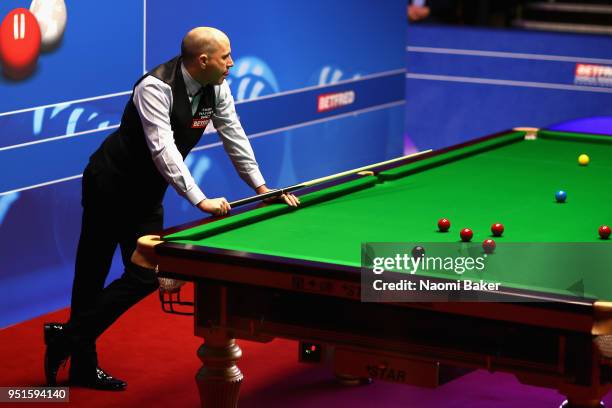 Joe Perry of England reacts during his second round match against Mark Allen of Northern Ireland during day six of the World Snooker Championship at...