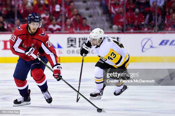 Lars Eller of the Washington Capitals skates with the puck against Conor Sheary of the Pittsburgh Penguins in the first period in Game One of the...