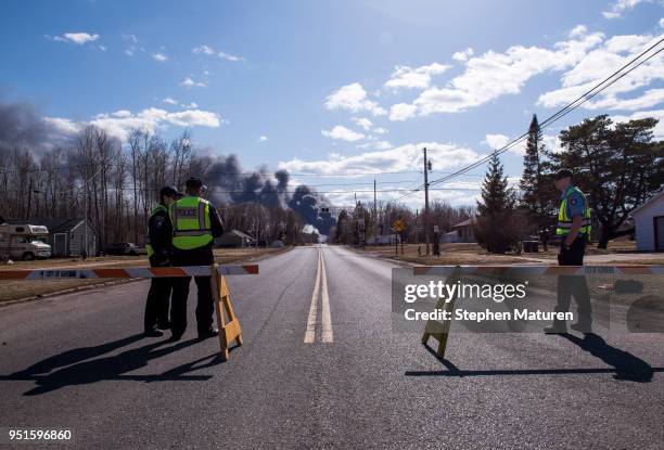 Police manage a road blockade near a fire at Husky Oil Refinery on April 26, 2018 in Superior, Wisconsin. Evacuations have been ordered in the areas...