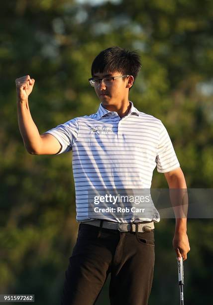Zecheng Dou of China makes his putt on the 18th green to tie for the lead during the first round of the Zurich Classic at TPC Louisiana on April 26,...