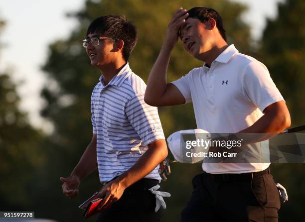 Zecheng Dou of China makes his putt on the 18th green to tie for the lead during the first round of the Zurich Classic at TPC Louisiana on April 26,...