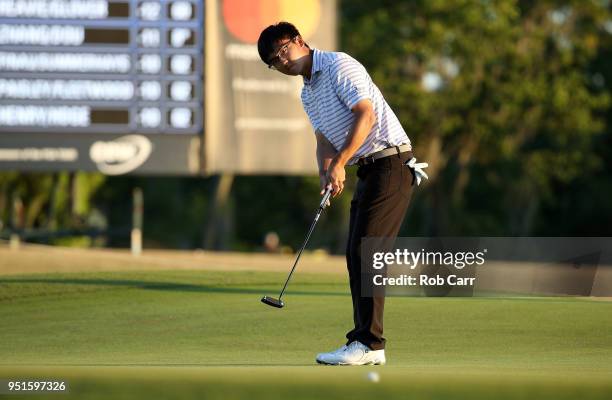 Zecheng Dou of China makes his putt on the 18th green to tie for the lead during the first round of the Zurich Classic at TPC Louisiana on April 26,...