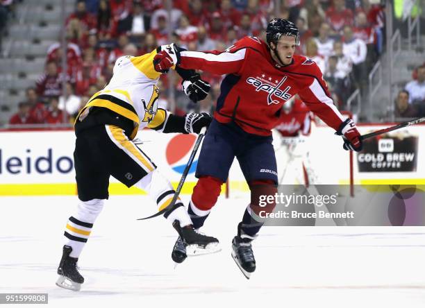 Bryan Rust of the Pittsburgh Penguins checks John Carlson of the Washington Capitals during the second period in Game One of the Eastern Conference...