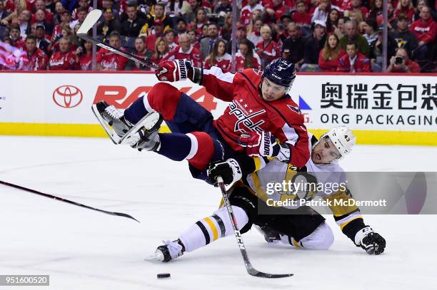 Dmitry Orlov of the Washington Capitals and Conor Sheary of the Pittsburgh Penguins battle for the puck in the second period in Game One of the...