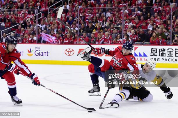 Dmitry Orlov of the Washington Capitals and Conor Sheary of the Pittsburgh Penguins battle for the puck in the second period in Game One of the...