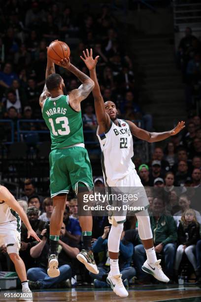 Khris Middleton of the Milwaukee Bucks jumps to block the shot of Marcus Morris of the Boston Celtics in Game Six of the Round One of the 2018 NBA...