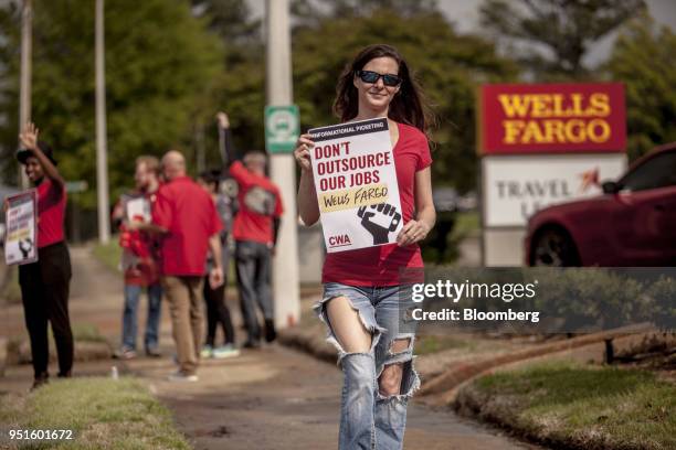 Demonstrator holds a sign during a protest against Wells Fargo & Co.'s plans to offshore thousands of jobs in Memphis, Tennessee, U.S., on Thursday,...