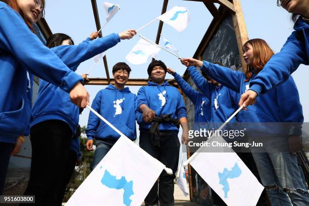 South Koreans react while watching a screen reporting the Inter Korean Summit on April 27, 2018 in Paju, South Korea. North Korean leader Kim Jong Un...