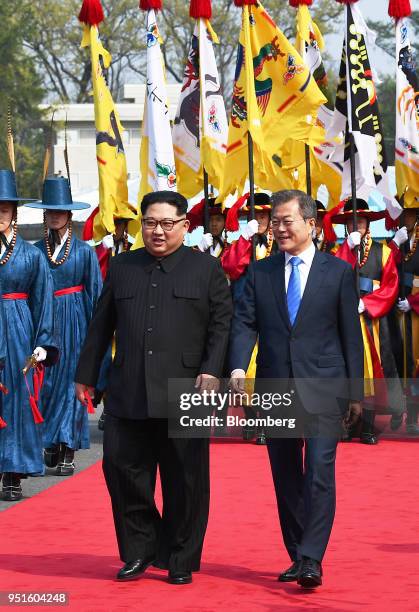 South Korean President Moon Jae-in, right, and North Korean leader Kim Jong Un pass an honor guard in the truce village of Panmunjom in the...