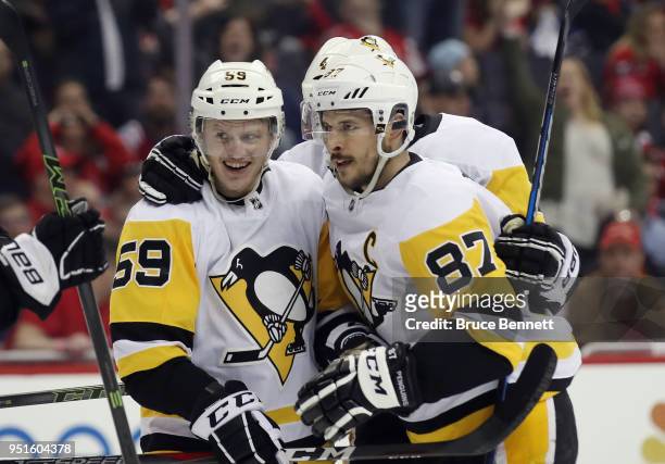 Jake Guentzel of the Pittsburgh Penguins celebrates his game winning goal at 7:48 of the third period against the Washington Capitals and is joined...