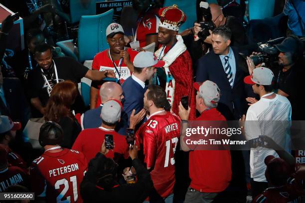 Josh Rosen of UCLA walks among fans after being picked overall by the Arizona Cardinals during the first round of the 2018 NFL Draft at AT&T Stadium...