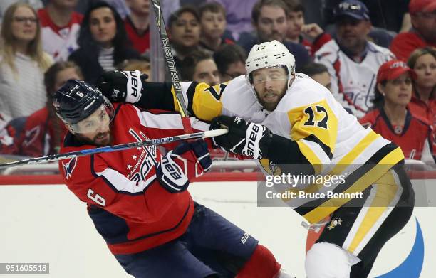 Bryan Rust of the Pittsburgh Penguins checks Michal Kempny of the Washington Capitals during the third period in Game One of the Eastern Conference...