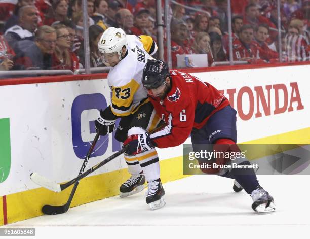 Conor Sheary of the Pittsburgh Penguins is checked by Michal Kempny of the Washington Capitals during the third period in Game One of the Eastern...