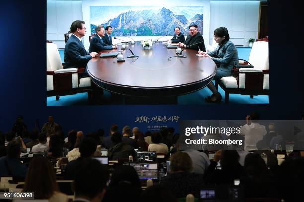 Members of the media watch a screen, showing the summit between South Korea's President Moon Jae-in and North Korean leader Kim Jong Un...