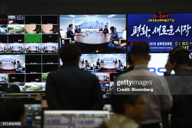 Members of the media watch screens, showing the summit between South Korea's President Moon Jae-in and North Korean leader Kim Jong Un...