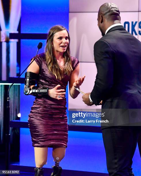 Oksana Masters accepts the Female Paralympic Athlete of the Games award with Vernon Davis during the Team USA Awards at the Duke Ellington School of...