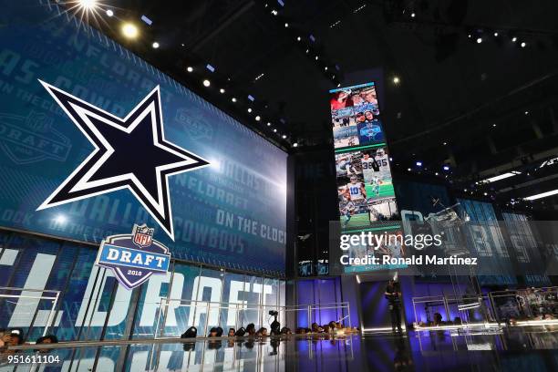 The Dallas Cowboys logo is seen on a video board during the first round of the 2018 NFL Draft at AT&T Stadium on April 26, 2018 in Arlington, Texas.