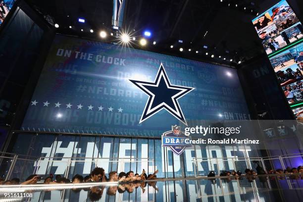 The Dallas Cowboys logo is seen on a video board during the first round of the 2018 NFL Draft at AT&T Stadium on April 26, 2018 in Arlington, Texas.