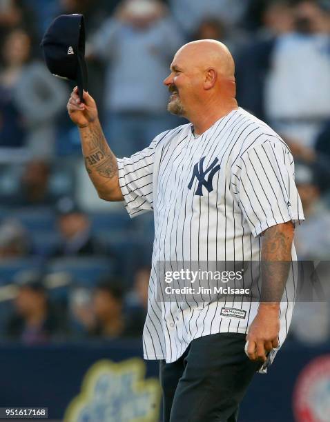 Former New York Yankee David Wells throws the ceremonial first pitch of a game between the Yankees and the Minnesota Twins at Yankee Stadium on April...