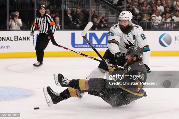 James Neal of the Vegas Golden Knights is checked off the puck by Brent Burns of the San Jose Sharks in the second period Game One of the Western...