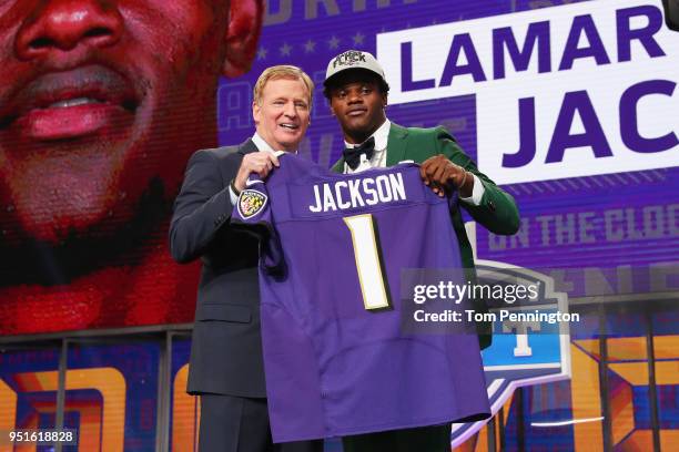 Lamar Jackson of Louisville poses with NFL Commissioner Roger Goodell after being picked overall by the Baltimore Ravens during the first round of...