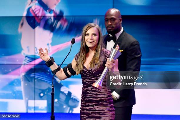 Oksana Masters accepts the Female Paralympic Athlete of the Games from Vernon Davis during the Team USA Awards at the Duke Ellington School of the...
