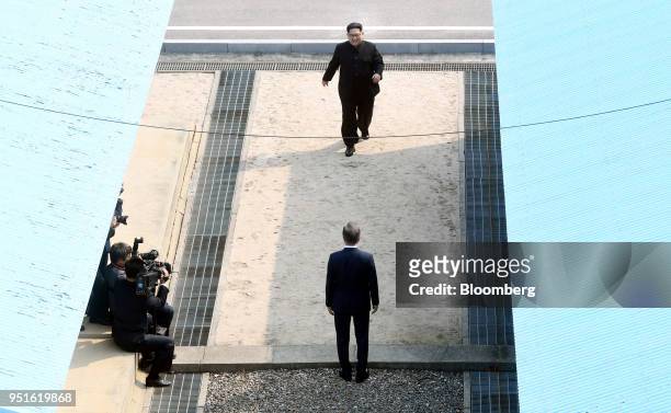 North Korean leader Kim Jong Un, top, walks towards South Korean President Moon Jae-in at the truce village of Panmunjom in the Demilitarized Zone in...