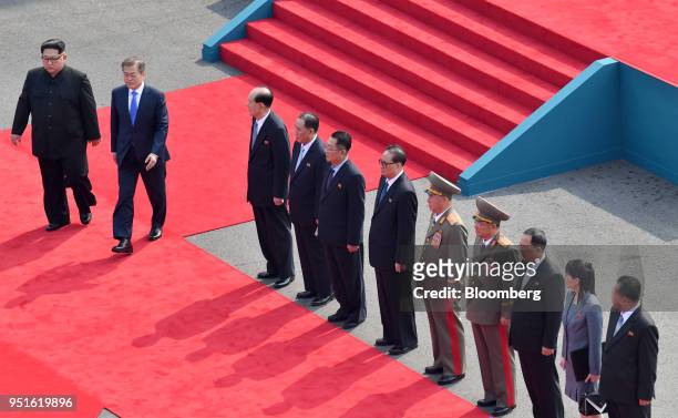 South Korean President Moon Jae-in, second from left, and North Korean leader Kim Jong Un, left, walk down a red carpet as North Korean...
