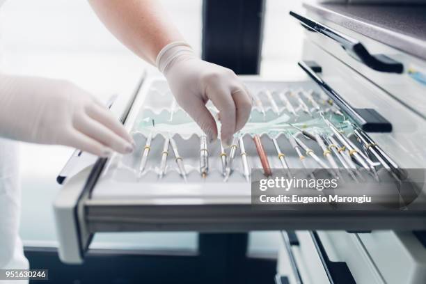 dental nurse preparing dentistry equipment, close-up - surgical tray stock pictures, royalty-free photos & images