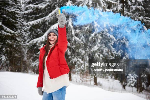 young woman with smoke flare in snow - gpointstudio imagens e fotografias de stock