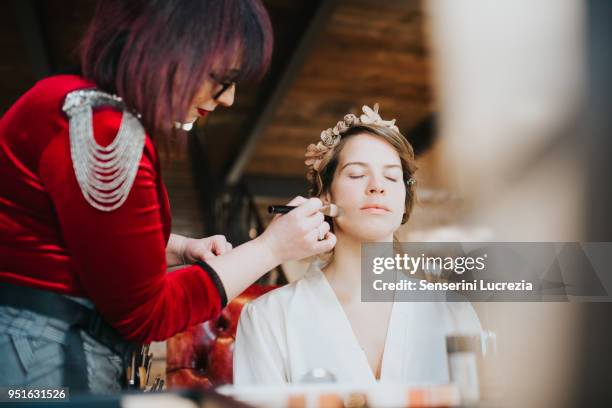 bride preparing for wedding with make-up artist - bridal makeup stock pictures, royalty-free photos & images