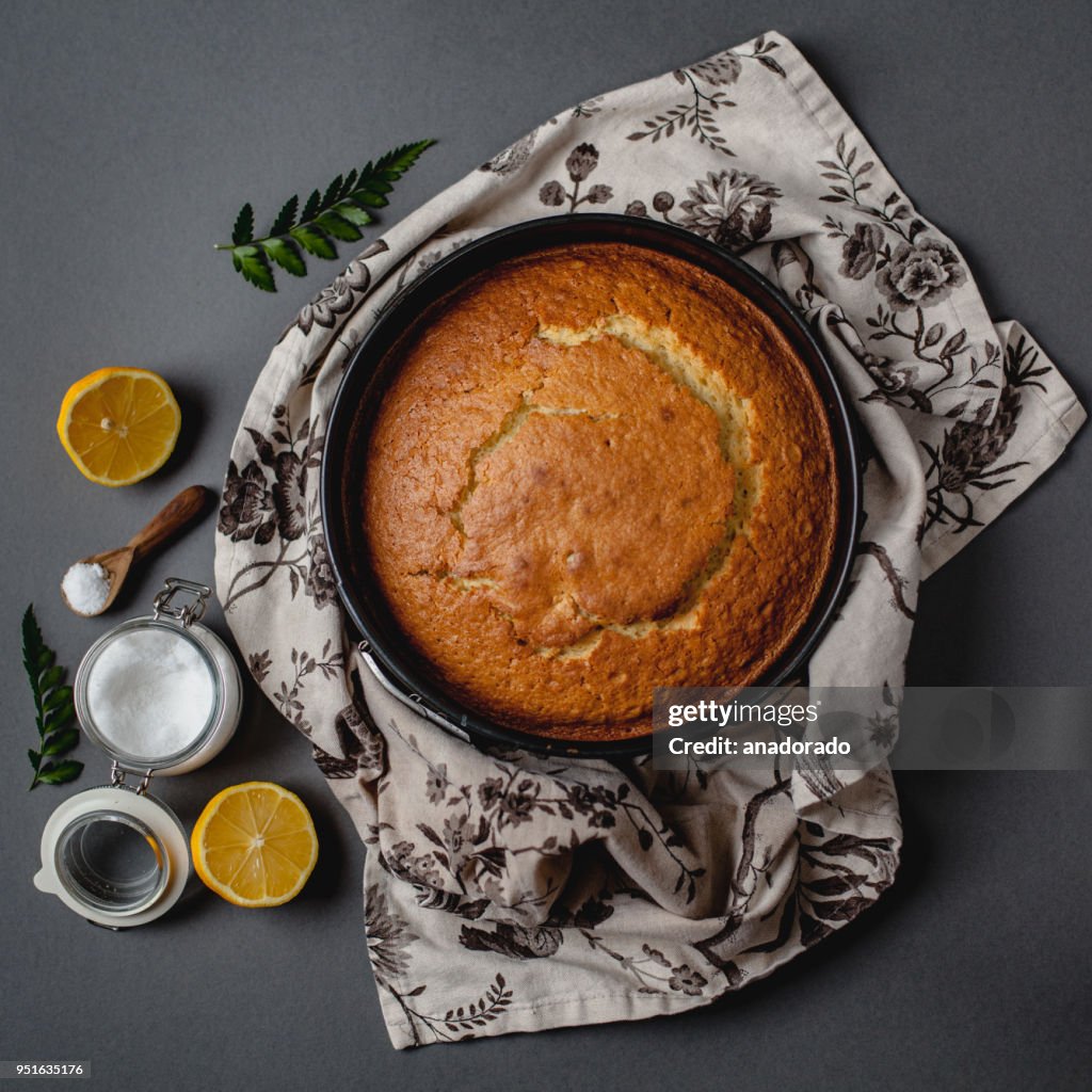 Sponge cake, sugar bowl, lemon and floral napkin