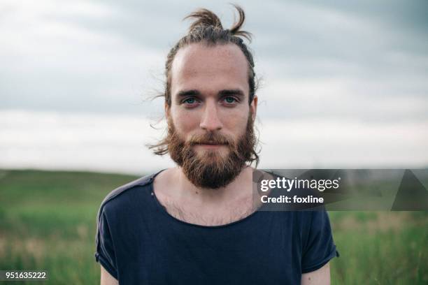 portrait of a handsome man with a top knot - hipster fotografías e imágenes de stock