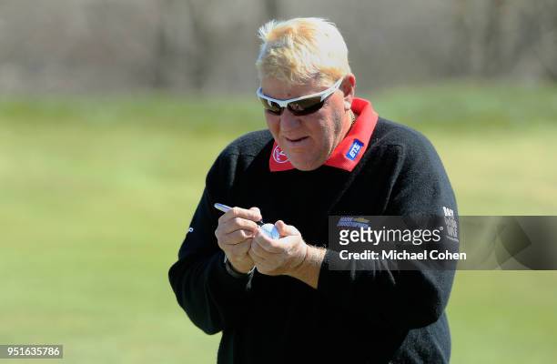 John Daly marks his ball during the first round of the PGA TOUR Champions Bass Pro Shops Legends of Golf held at Buffalo Ridge Golf Club on April 19,...