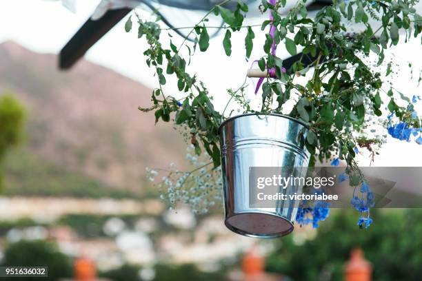 floral decoration hanging in a bucket - metal bucket stock pictures, royalty-free photos & images